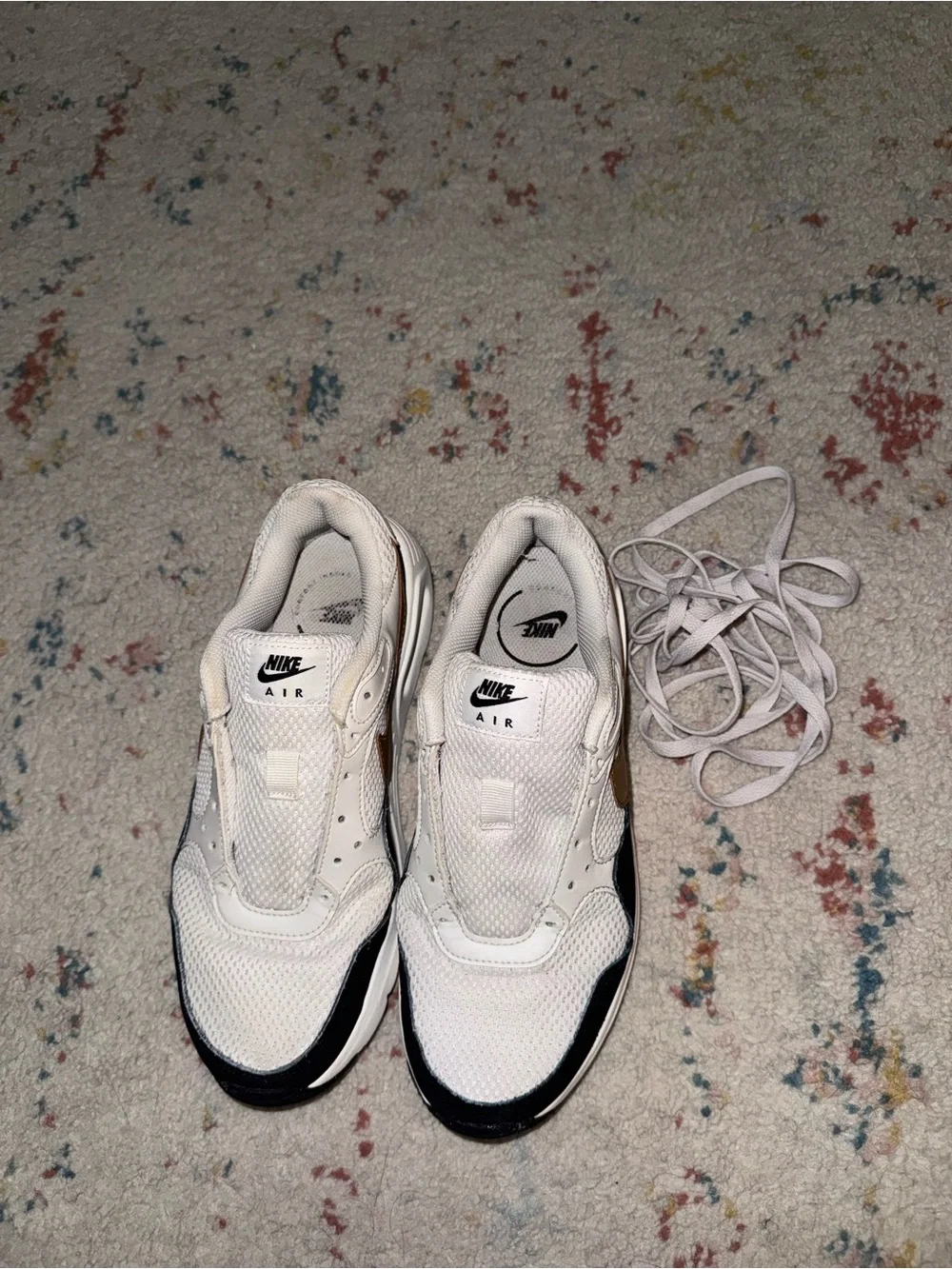 Nike White Sneakers with Black Trim and Gold Swoosh